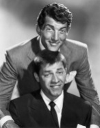 circa 1955: American comic team Dean Martin (1917 - 1995) and Jerry Lewis smiling in a promotional portrait. Martin smiles and rests his chin on top of Lewis's head, as Lewis makes a funny face.